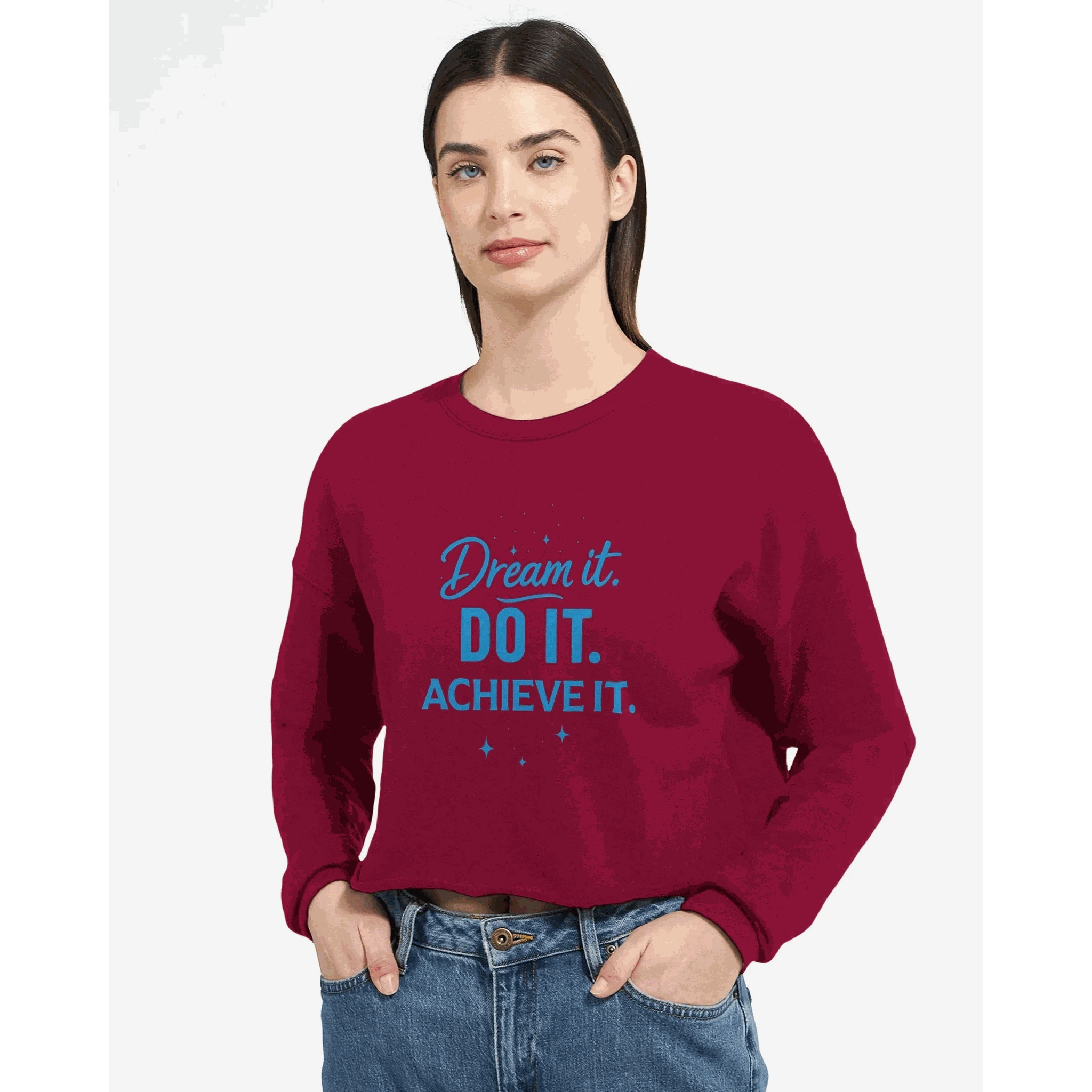 Woman wearing burgundy cropped sweatshirt with "Dream it. DO IT. ACHIEVE IT." motivational text in blue