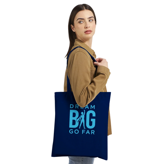 Woman carrying navy blue Dream BIG tote bag with motivational text and silhouette design