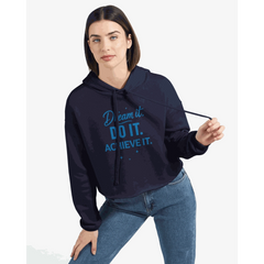 Woman wearing navy cropped motivational hoodie with "Dream it DO IT ACHIEVE IT" text and raw hem