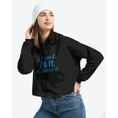 Woman wearing black cropped hoodie with "Dream It. DO IT. ACHIEVE IT." motivational text in blue and white beanie