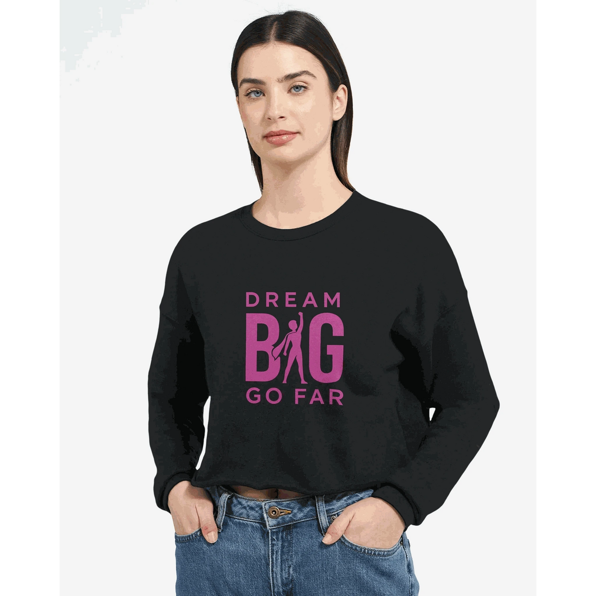 Dream BIG woman wearing black cropped sweatshirt with pink "Dream BIG Go Far" motivational text design