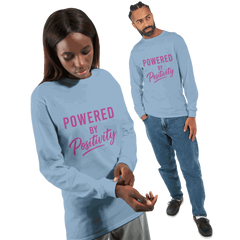 Unisex long sleeve t-shirt in light blue with "Powered by Positivity" motivational text in pink font