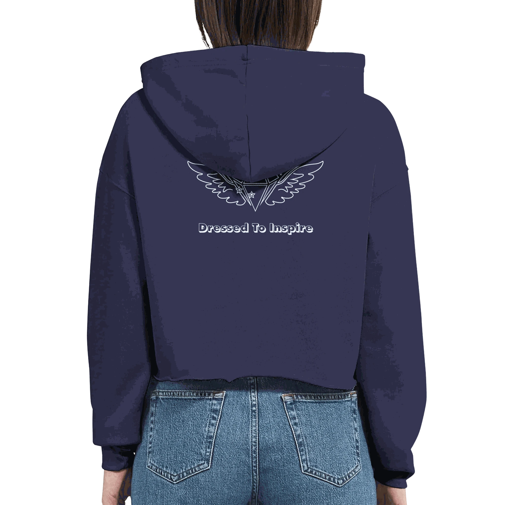 Woman wearing navy cropped hoodie with "Dressed To Inspire" and wing logo on back, paired with blue jeans, motivational fashion sweatshirt Dream It. DO IT.