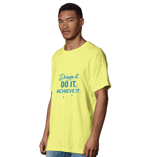Man wearing yellow organic oversized men's t-shirt with blue "Dream it. DO IT. ACHIEVE IT." motivational text