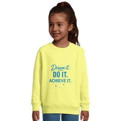 Child wearing yellow recycled kids motivational sweatshirt with "Dream It. Do It. Achieve It." text