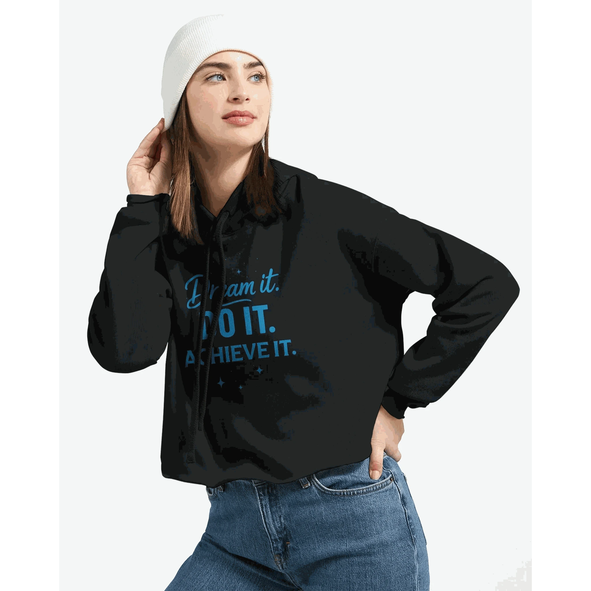 Woman wearing black cropped hoodie with "Dream It. DO IT. ACHIEVE IT." motivational text in blue and white beanie