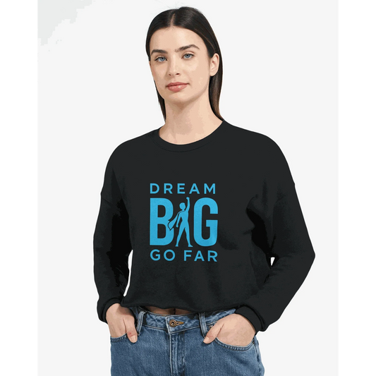 Woman wearing black cropped sweatshirt with blue "Dream BIG Go Far" motivational text design